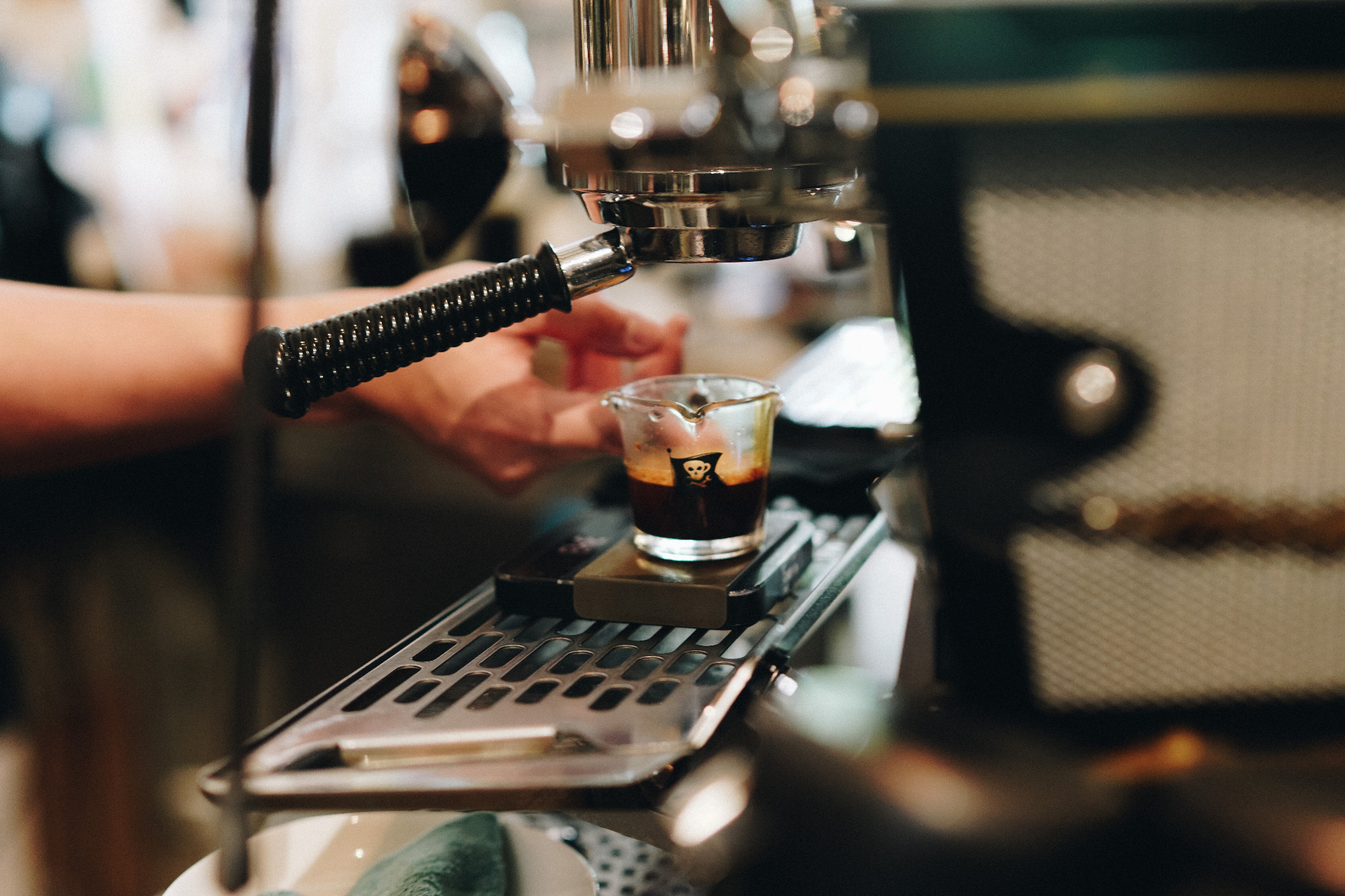 Espresso pulling into a glass on the machine